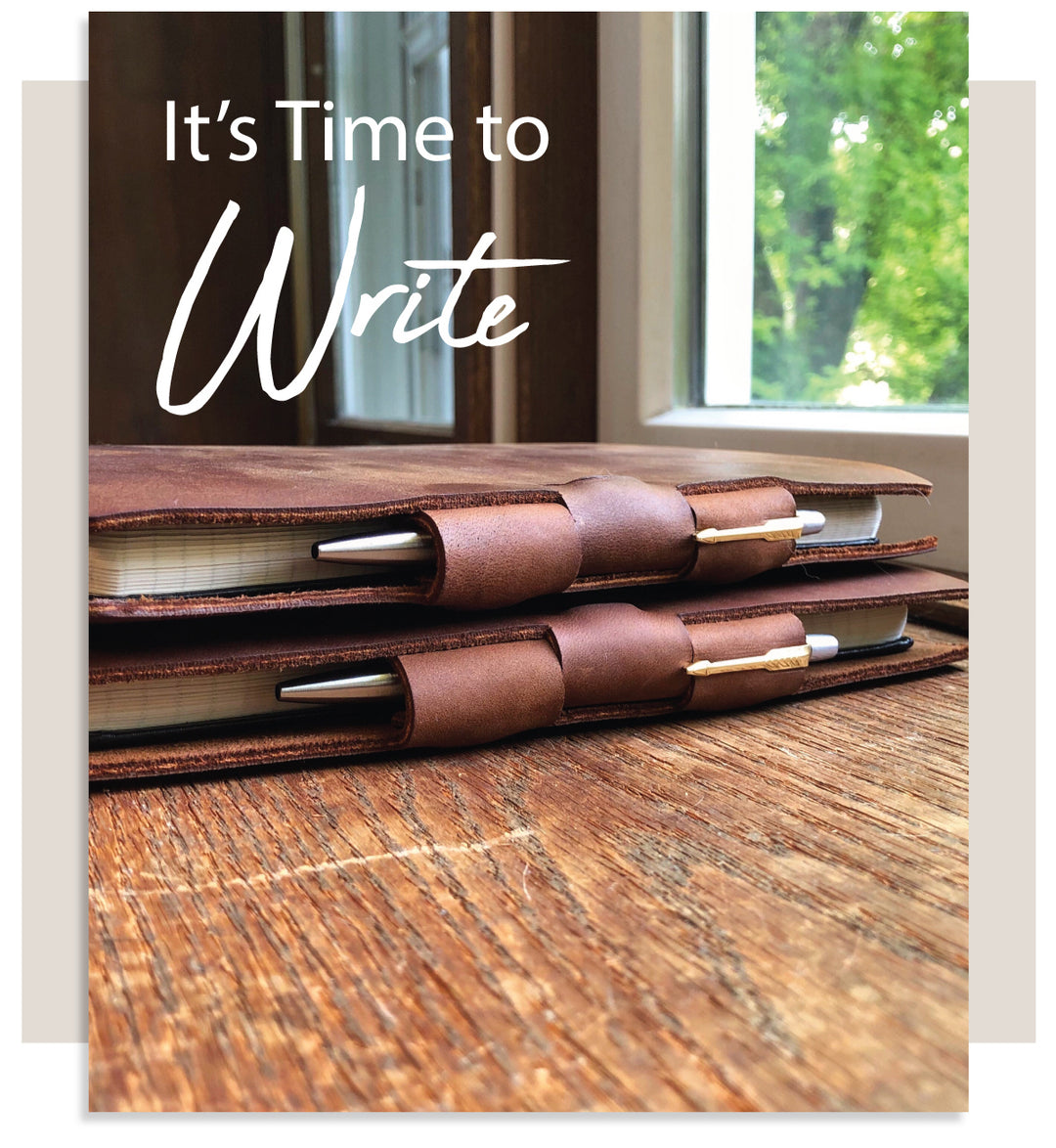 It's Time To Write - Pictured: Two Espresso Classic Cut Refillable Leather Journals with stainless steel Parker Jotter pens on a desk by a window with tress in the background.