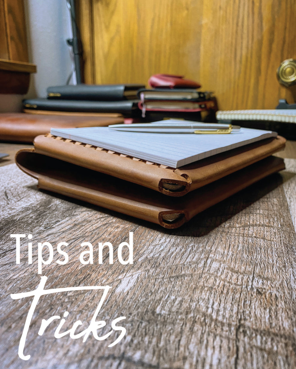 Tips and Tricks - Pictured: Travel Cut Refillable Leather Folio with Mini Legal Pad and Stainless Steel Parker Jotter Pen on a Desk with Leather Journals in the background